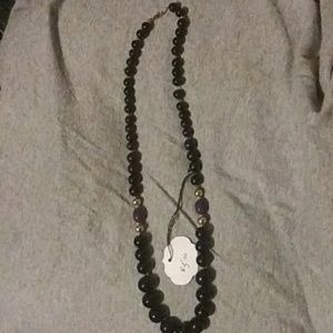 Black,gold, and two purple beaded necklace.